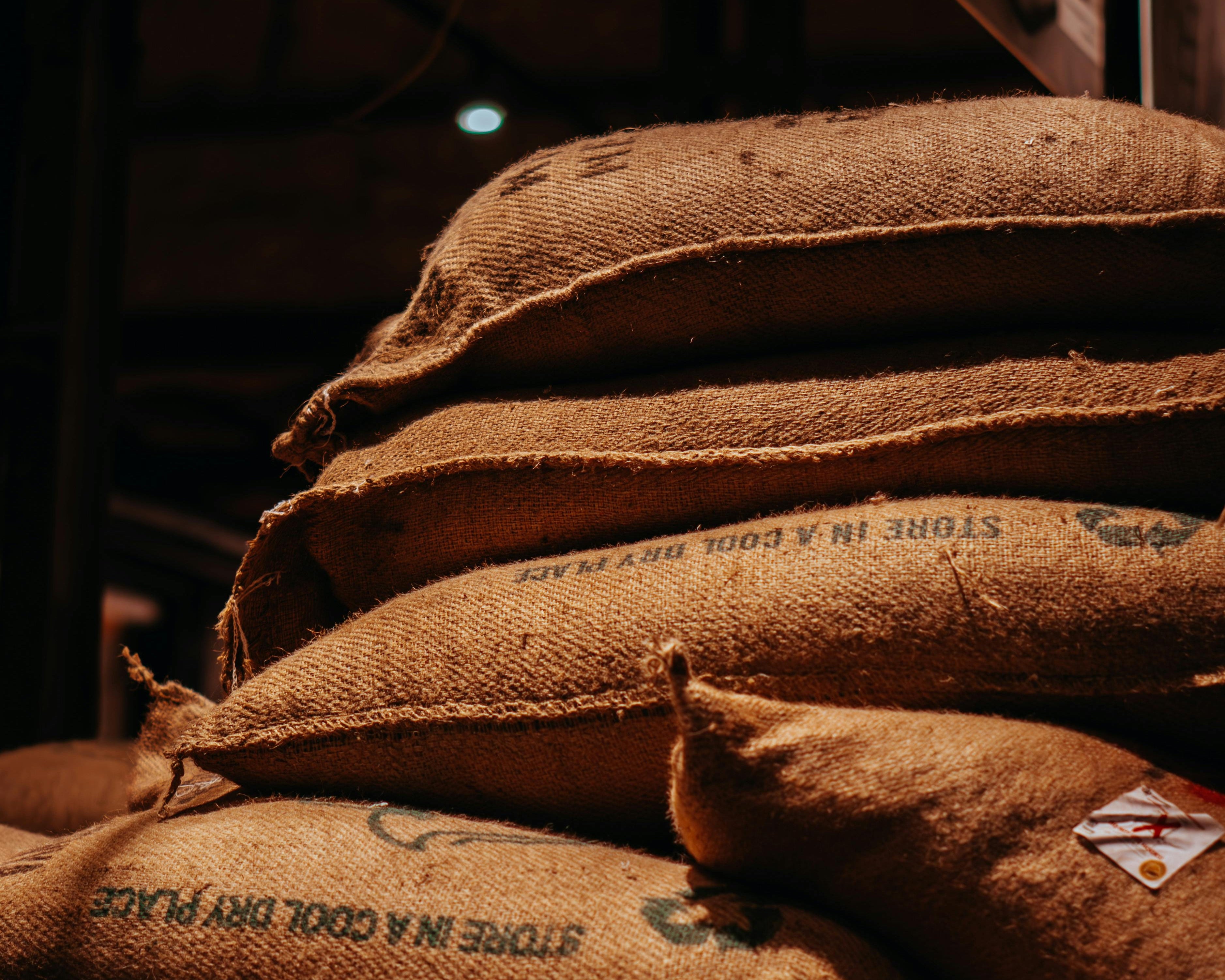 Stack of brown burlap sacks filled with arabica coffee